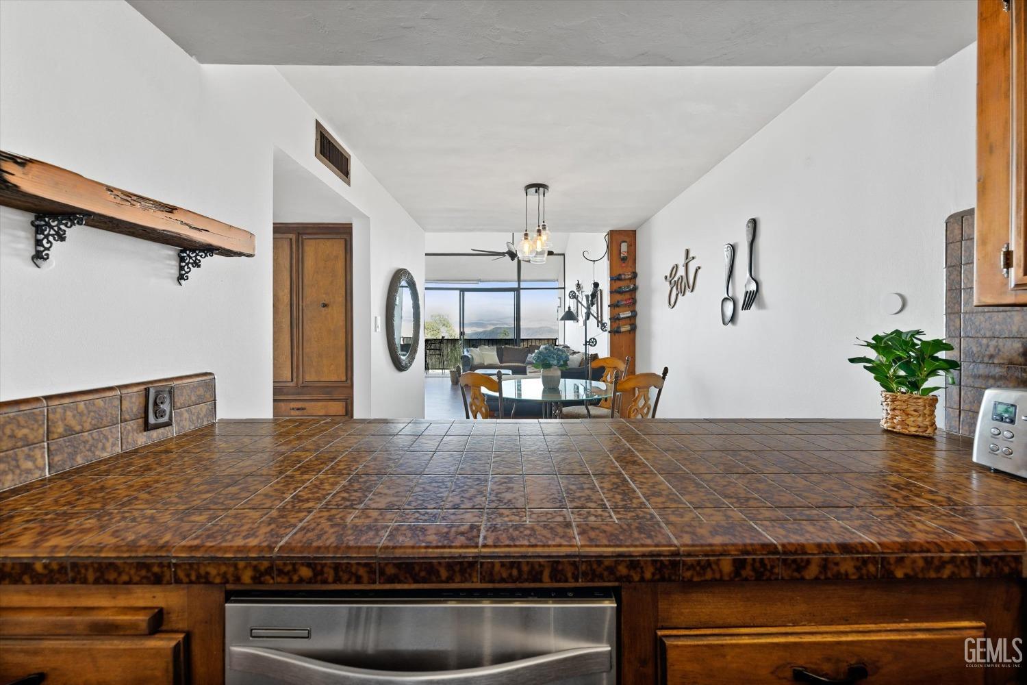 Undisclosed Address Bakersfield, CA 93306 - Photo 26 of 52 a kitchen with kitchen island granite countertop a sink and a stove