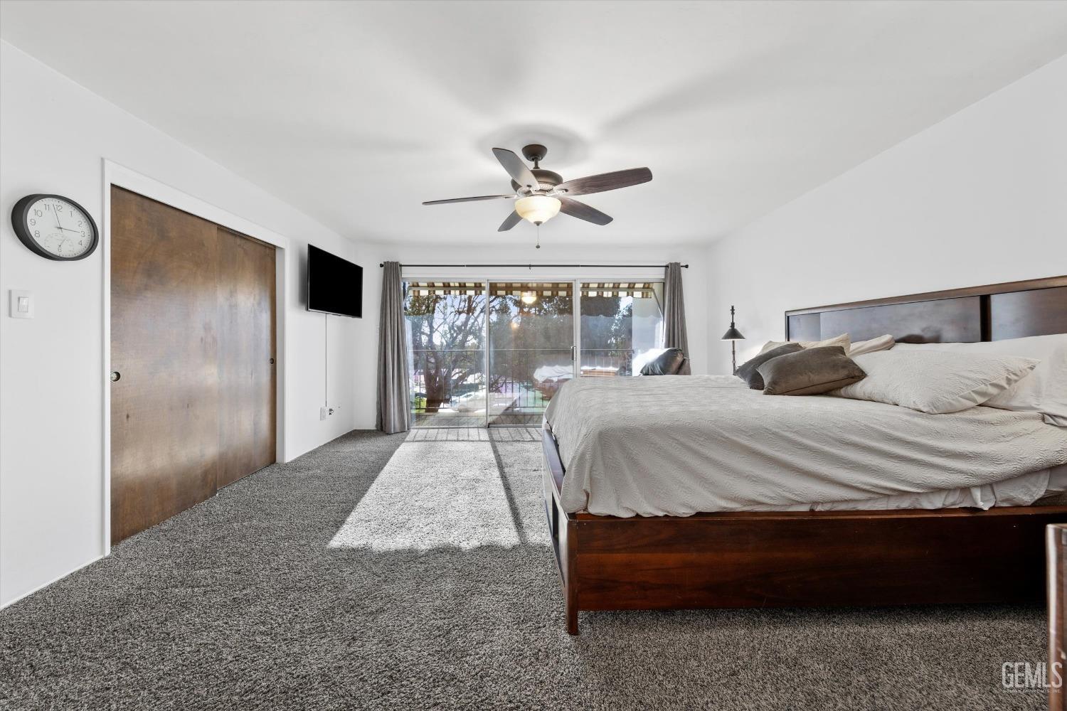 Undisclosed Address Bakersfield, CA 93306 - Photo 36 of 52 a bedroom with a large bed and a chandelier