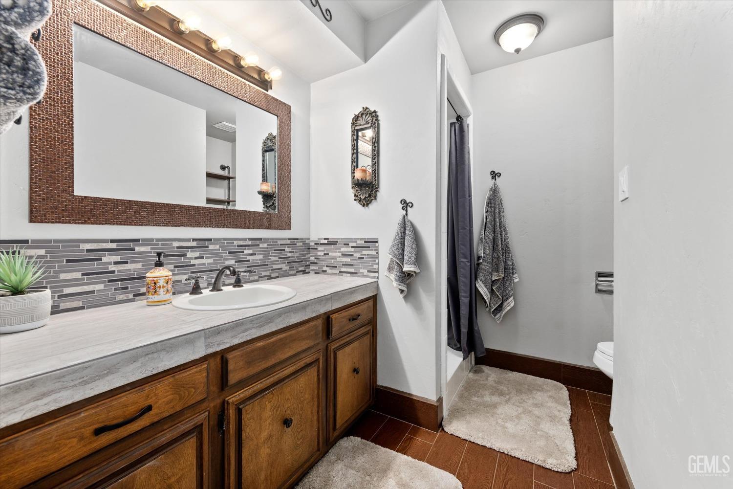 Undisclosed Address Bakersfield, CA 93306 - Photo 43 of 52 a bathroom with a sink and a mirror