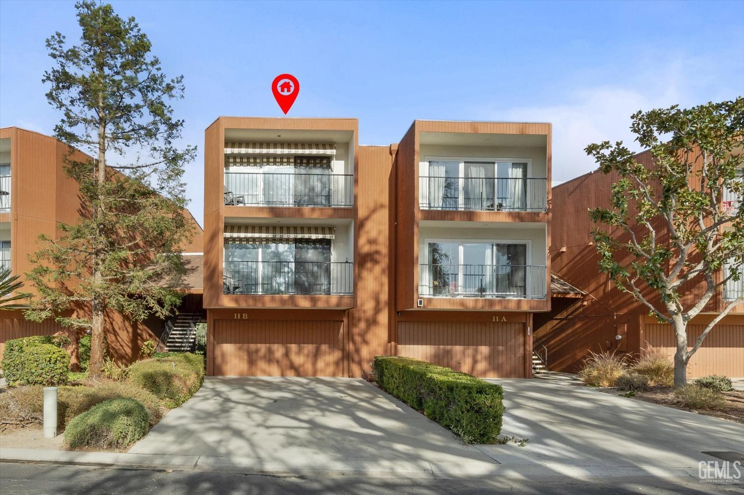 Undisclosed Address Bakersfield, CA 93306 - Photo 48 of 52 a view of a brick house with a small yard and large tree