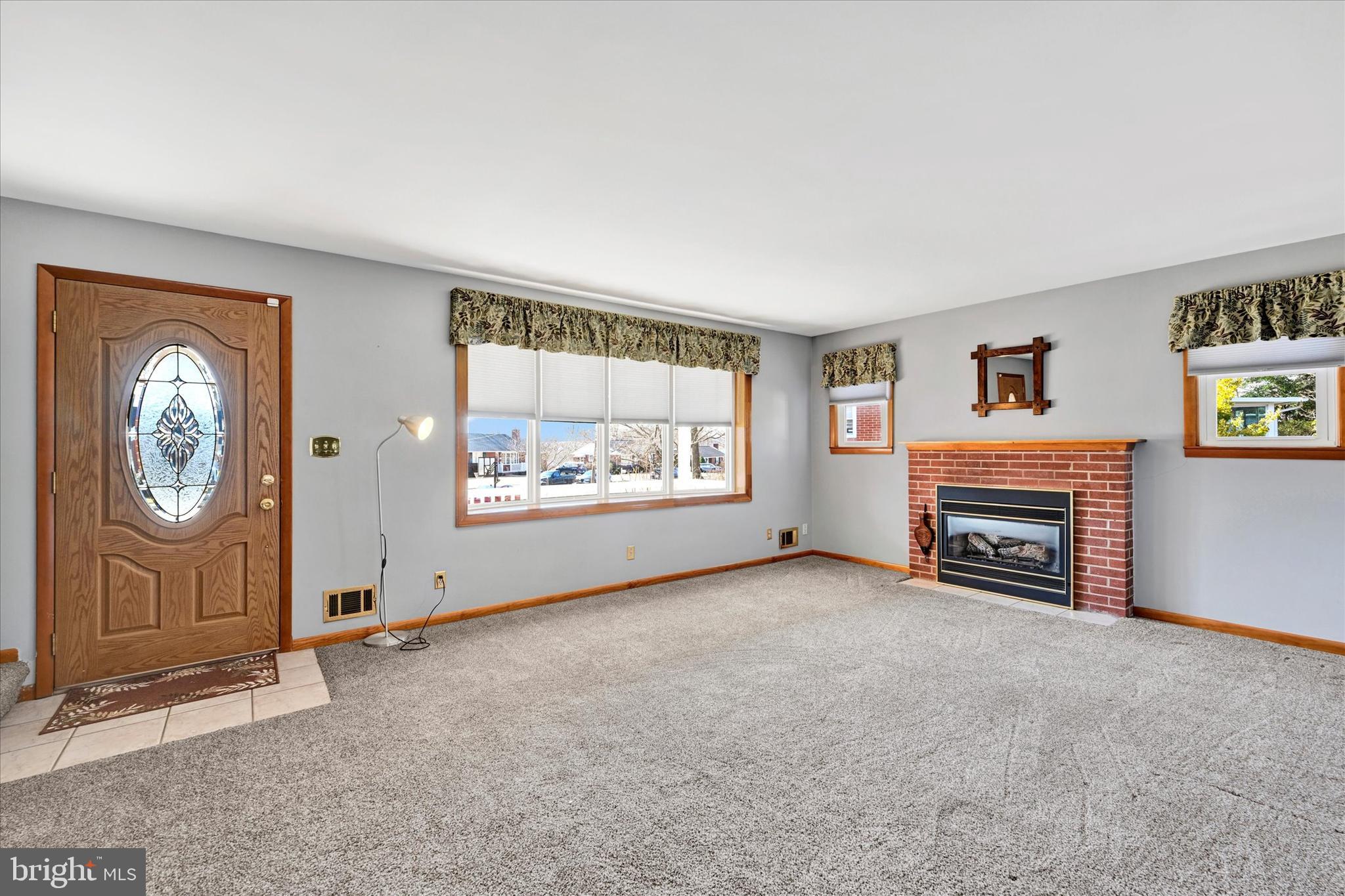 9914 Gunforge Road Perry Hall, MD 21128 - Photo 5 of 34 an empty room with windows a fireplace and cabinet