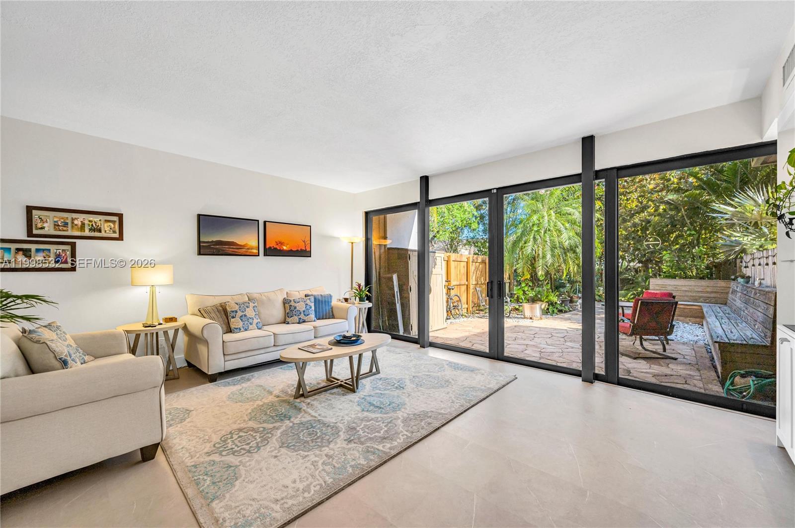 a living room with furniture and large windows