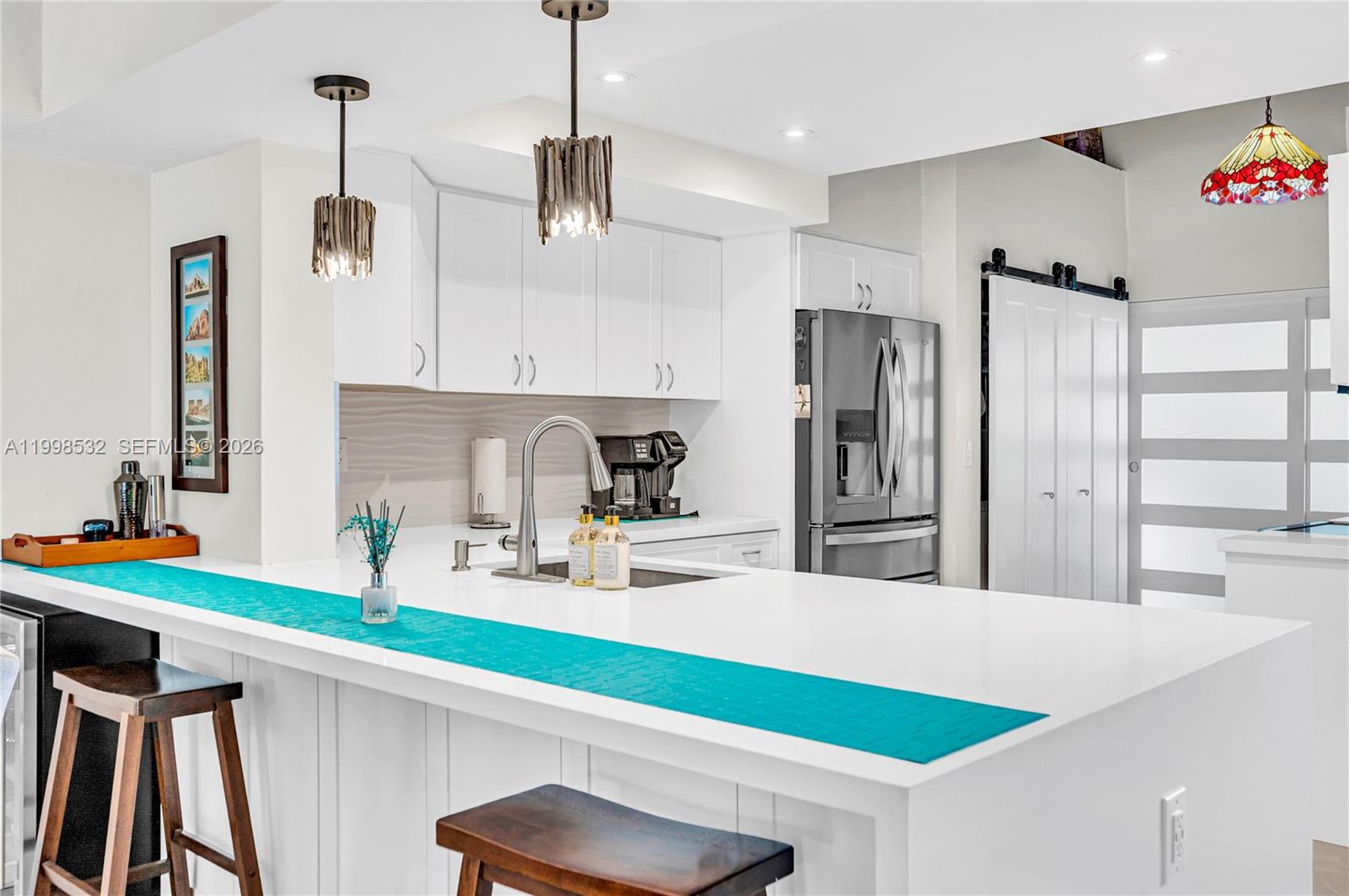 7018 Southwest 53rd Lane Miami, FL 33155 - Photo 12 of 58 a kitchen with stainless steel appliances kitchen island granite countertop a sink and refrigerator