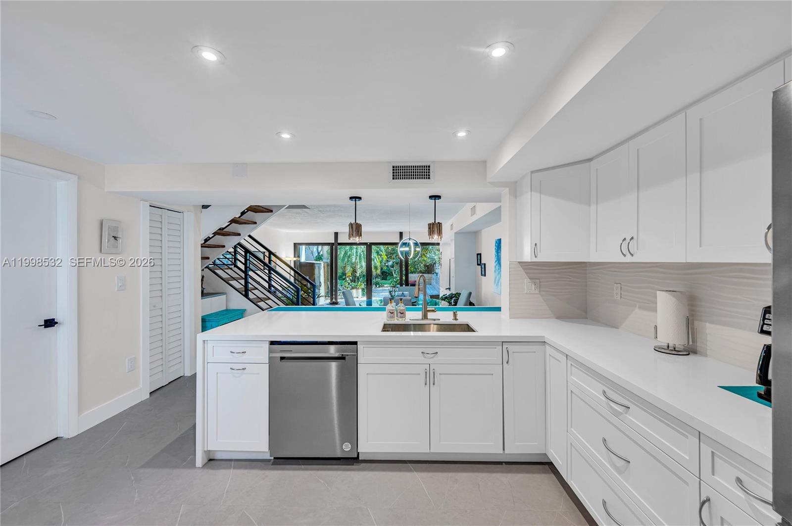 7018 Southwest 53rd Lane Miami, FL 33155 - Photo 15 of 58 a kitchen with white cabinets and white appliances
