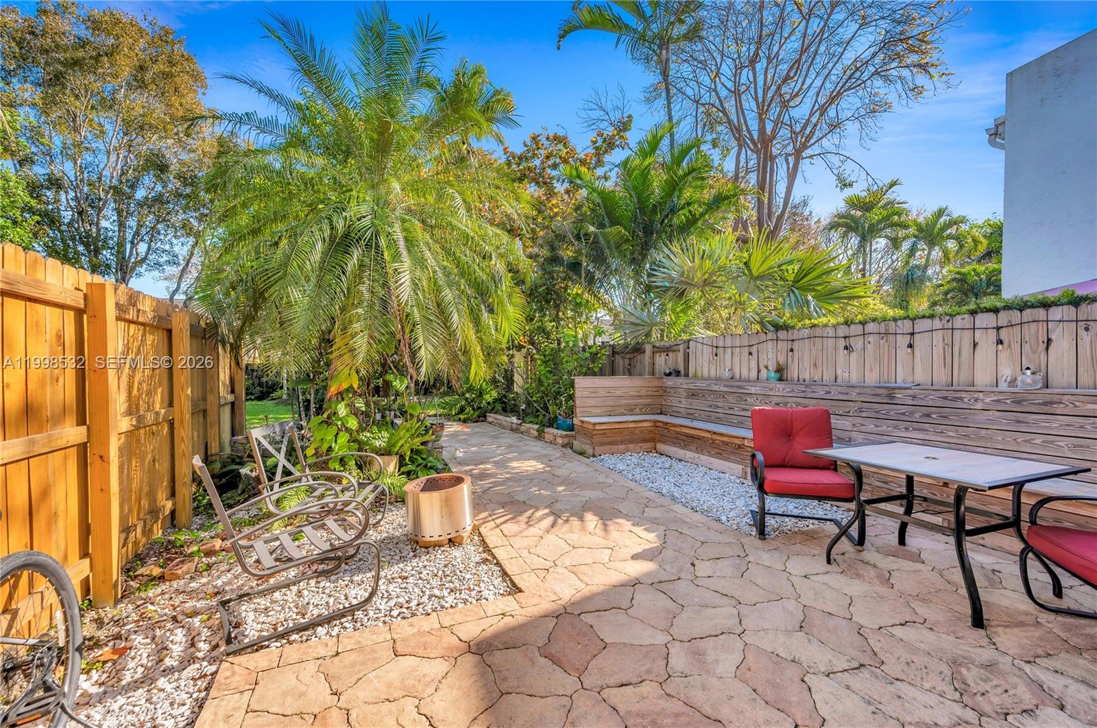 7018 Southwest 53rd Lane Miami, FL 33155 - Photo 17 of 58 a backyard of a house with barbeque oven table and chairs