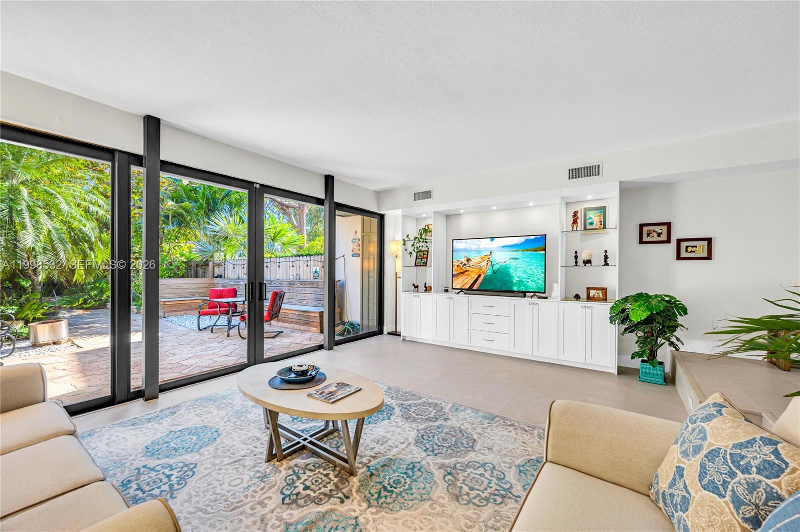 7018 Southwest 53rd Lane Miami, FL 33155 - Photo 2 of 58 a living room with furniture and a large window