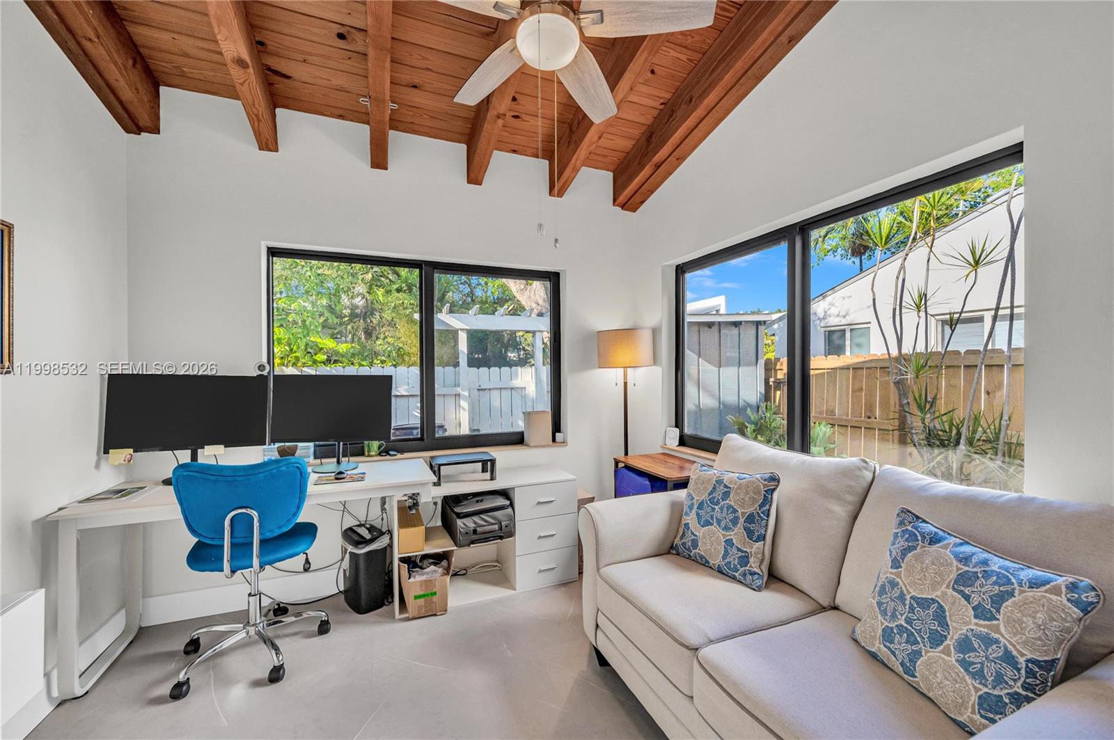 7018 Southwest 53rd Lane Miami, FL 33155 - Photo 21 of 59 a living room with furniture a ceiling fan and a large window