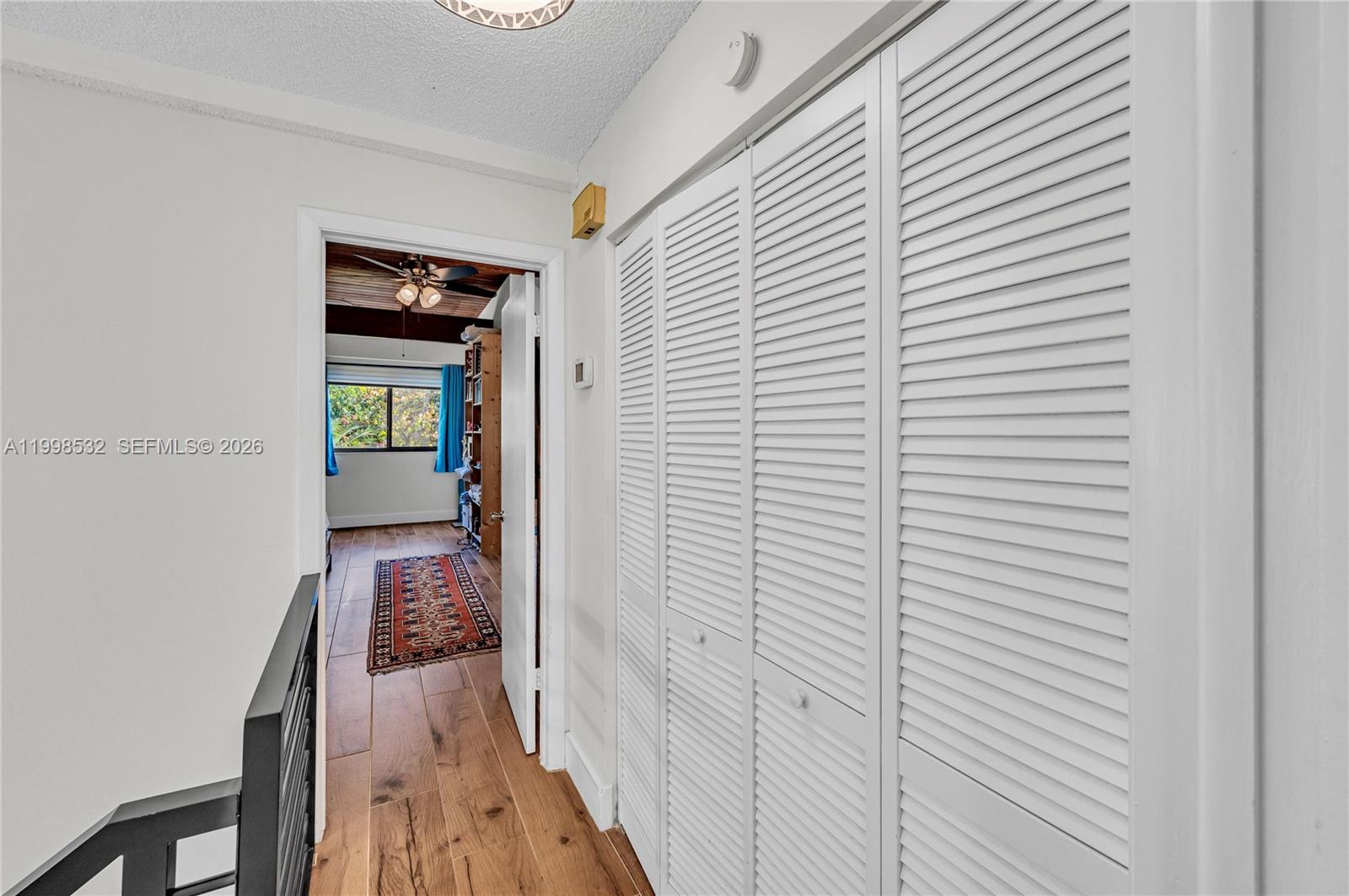 7018 Southwest 53rd Lane Miami, FL 33155 - Photo 34 of 58 a view of a hallway with wooden floor and a bathroom