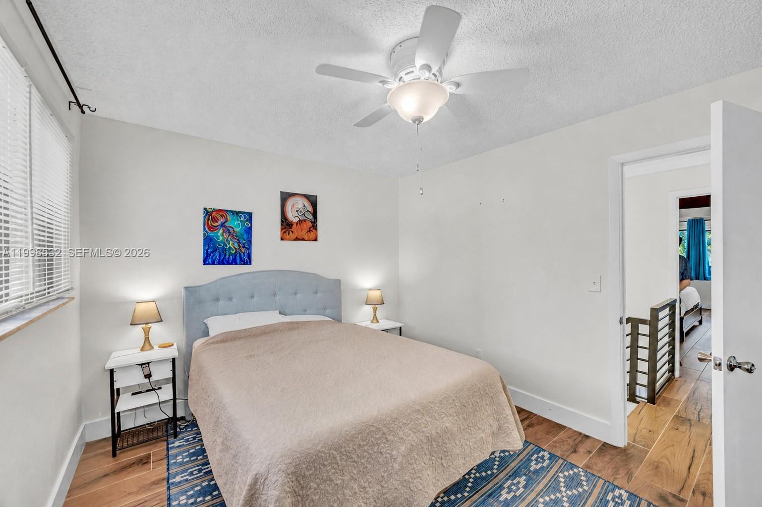 7018 Southwest 53rd Lane Miami, FL 33155 - Photo 36 of 59 a bedroom with a large bed and a chandelier