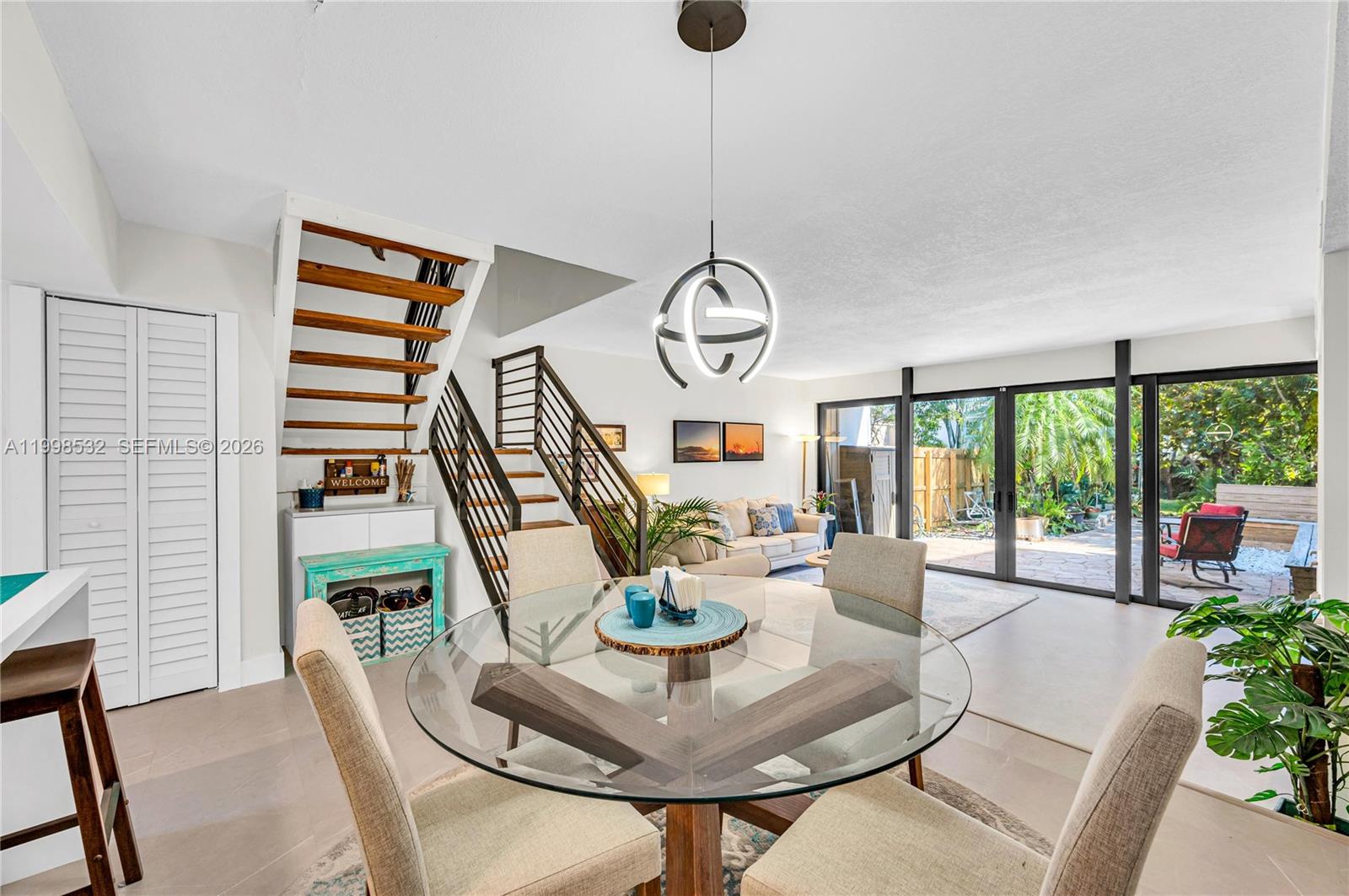 7018 Southwest 53rd Lane Miami, FL 33155 - Photo 5 of 58 a living room with furniture and a floor to ceiling window