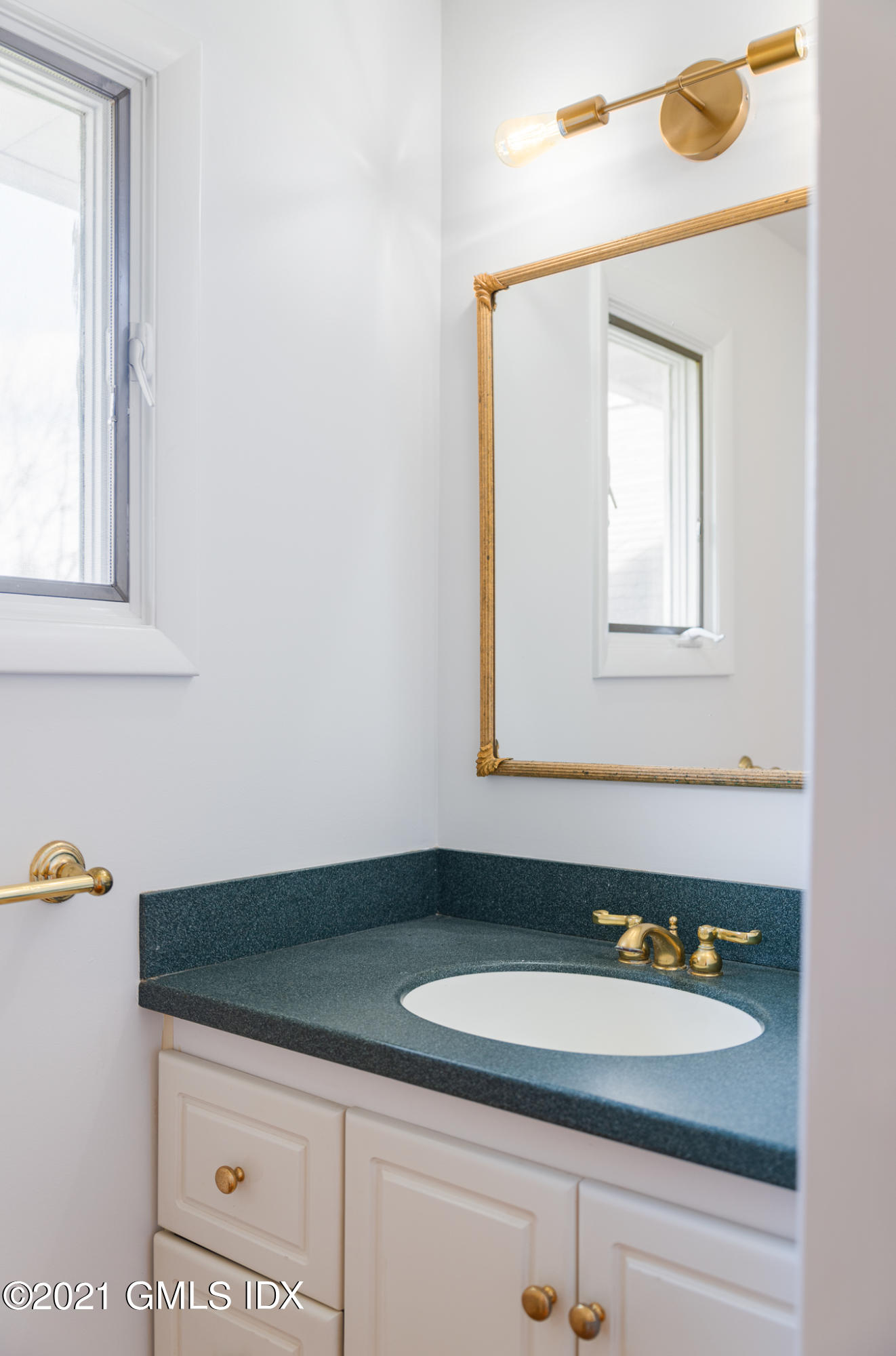 1 Norias Road Greenwich, CT 06830 - Photo 21 of 41 a bathroom with a sink and a mirror