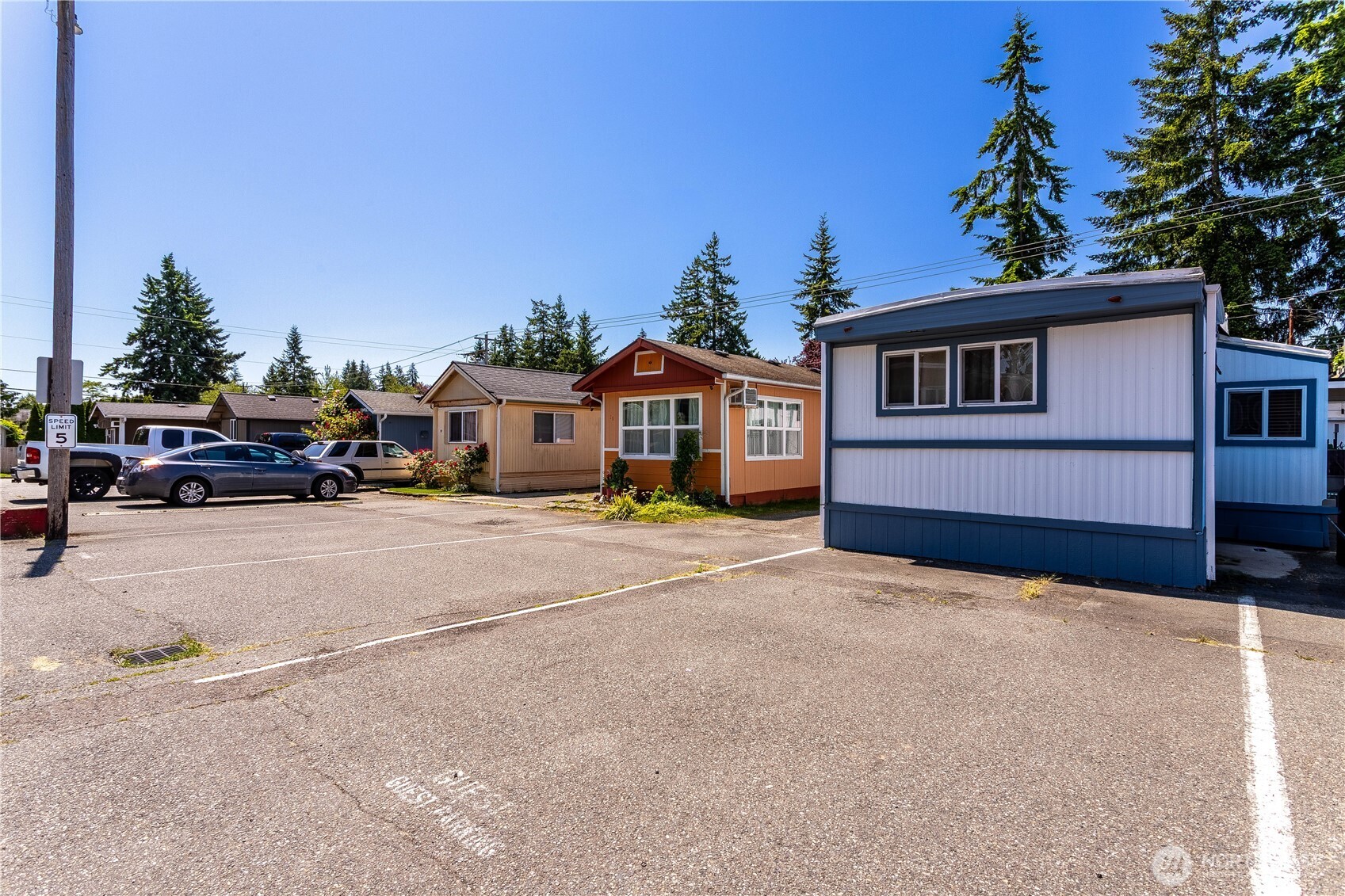 5920 200th Street Southwest, Unit 37 Lynnwood, WA 98036 - Photo 19 of 21 a front view of a house with a yard and garage