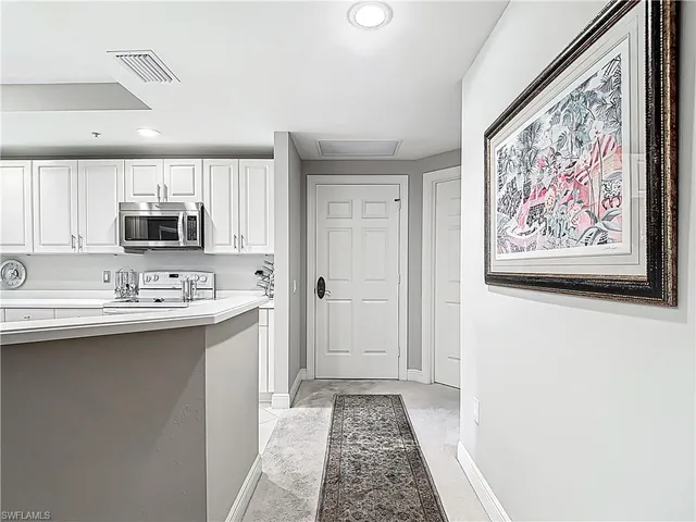 a kitchen with stainless steel appliances a sink and a microwave