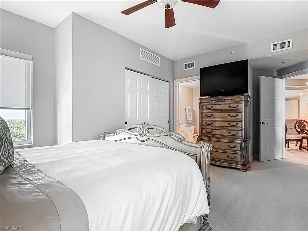 2745 First Street, Unit 1106 Fort Myers, FL 33916 - Photo 11 of 23 a bedroom with a bed and a flat screen tv