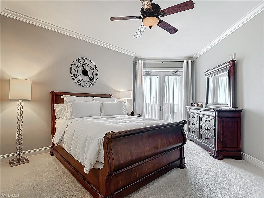 2745 First Street, Unit 1106 Fort Myers, FL 33916 - Photo 14 of 23 a bedroom with a bed and a chandelier