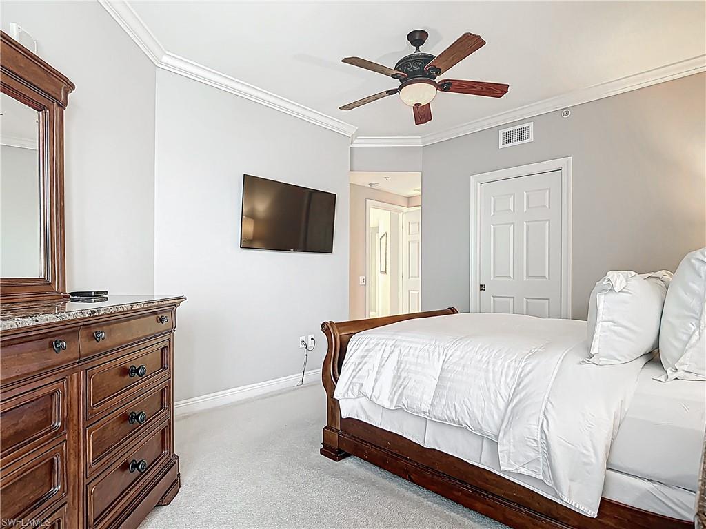 2745 First Street, Unit 1106 Fort Myers, FL 33916 - Photo 15 of 23 a bedroom with a bed and a flat screen tv