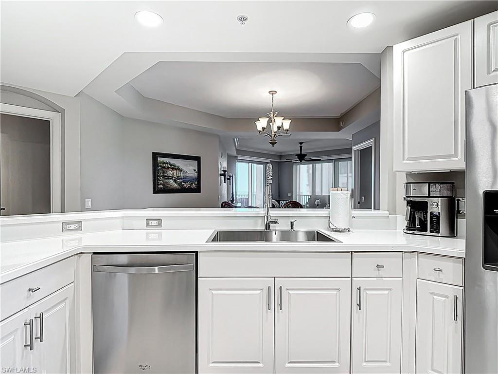 2745 First Street, Unit 1106 Fort Myers, FL 33916 - Photo 4 of 23 a kitchen with a sink dishwasher a stove with cabinets and couches
