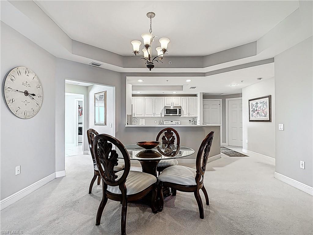 2745 First Street, Unit 1106 Fort Myers, FL 33916 - Photo 7 of 23 a dining room with furniture a chandelier and a window