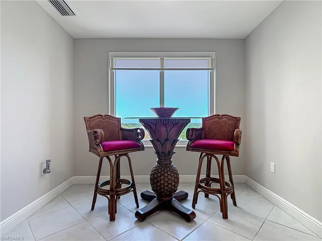 a dining room with furniture a chandelier and a window