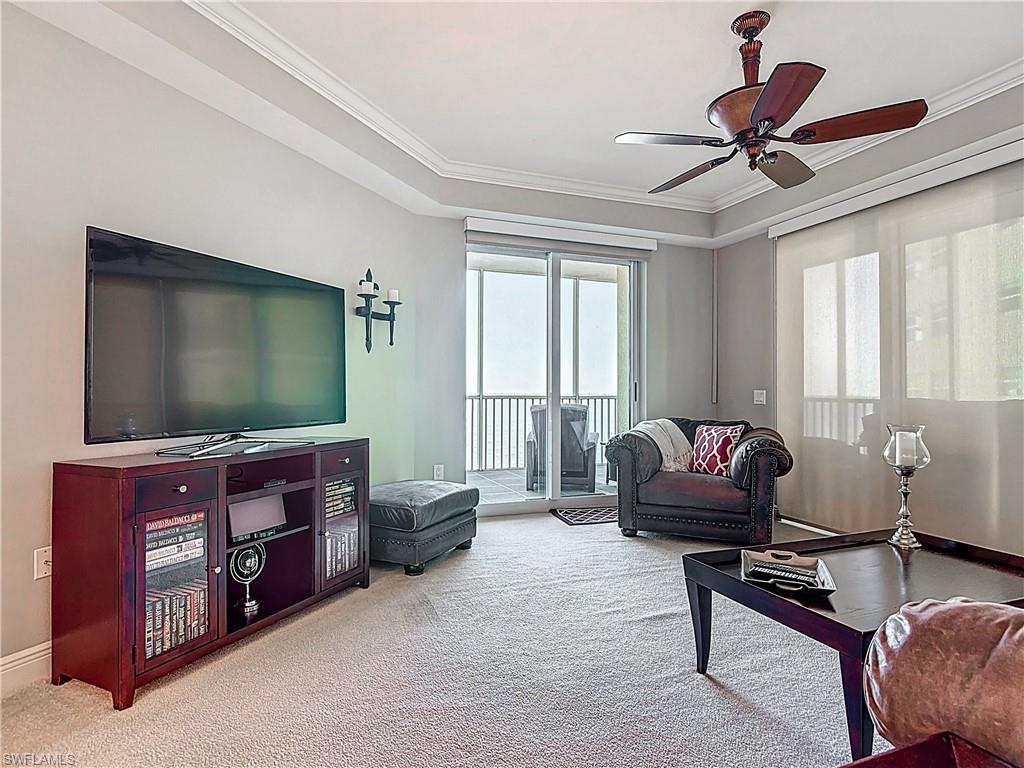 2745 First Street, Unit 1106 Fort Myers, FL 33916 - Photo 8 of 23 a living room with furniture and a flat screen tv