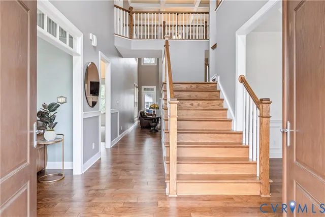 a view of entryway and hall with wooden floor
