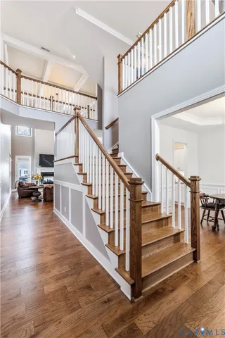 a view of entryway and hall with wooden floor