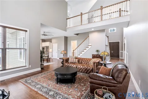 a living room with furniture a rug and a window