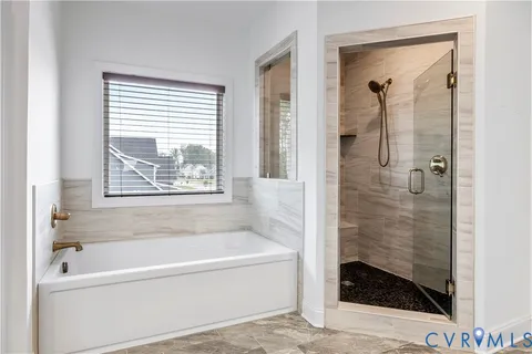 a bathroom with a bathtub and shower