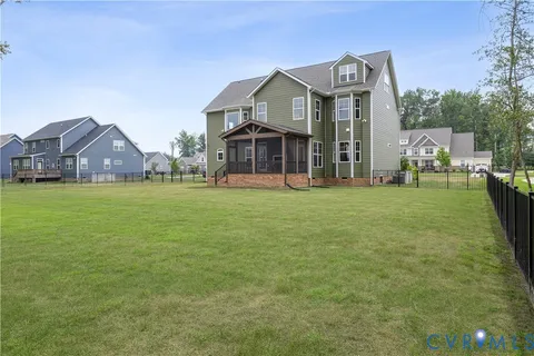 a front view of a house with yard and green space