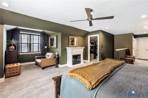 a bedroom with a bed couch and a window