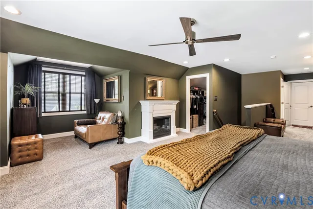 a bedroom with a bed couch and a window