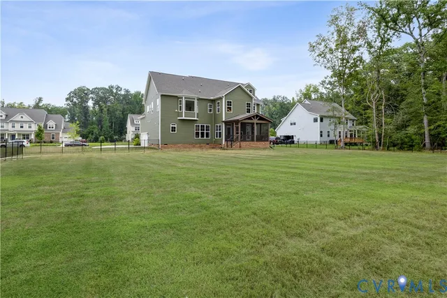 a front view of a house with a yard and trees