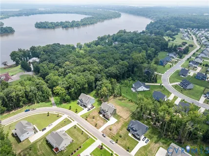 an aerial view of residential house with outdoor space and lake view
