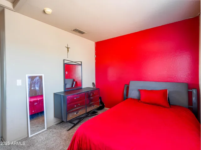 a bedroom with two bed and a closet