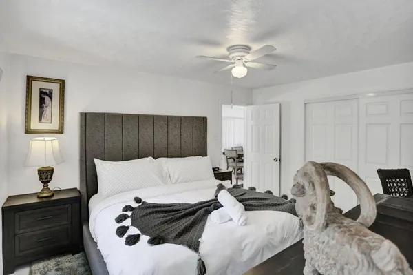 a bedroom with bed and a couch