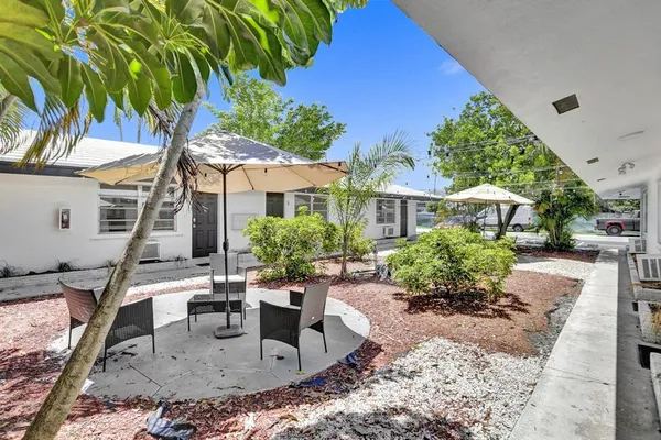 a view of a house with backyard porch and sitting area