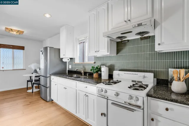 a kitchen with cabinets and stainless steel appliances