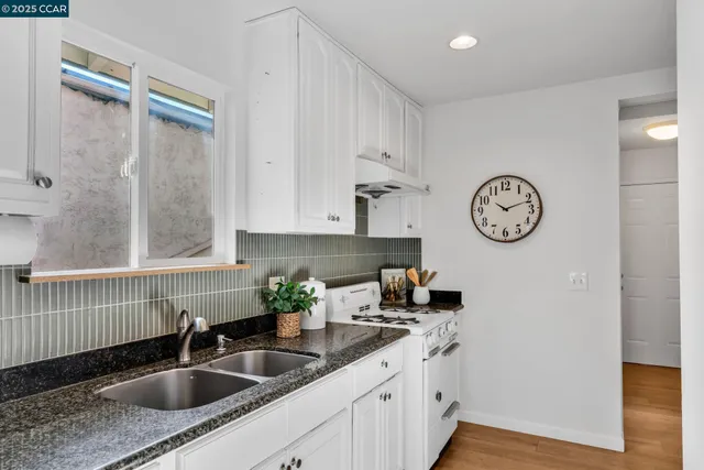 a view of a room with furniture and wooden floor