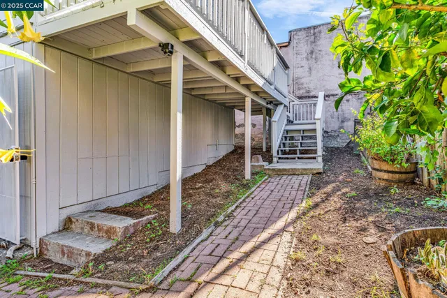 a view of a balcony with wooden floor and fence