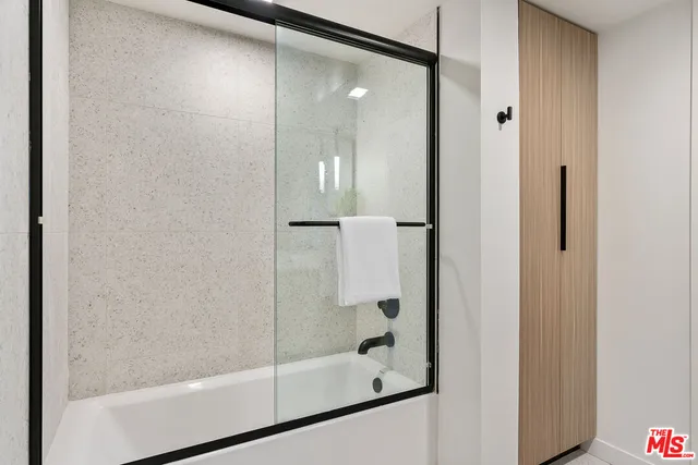 a bathroom with a glass shower door