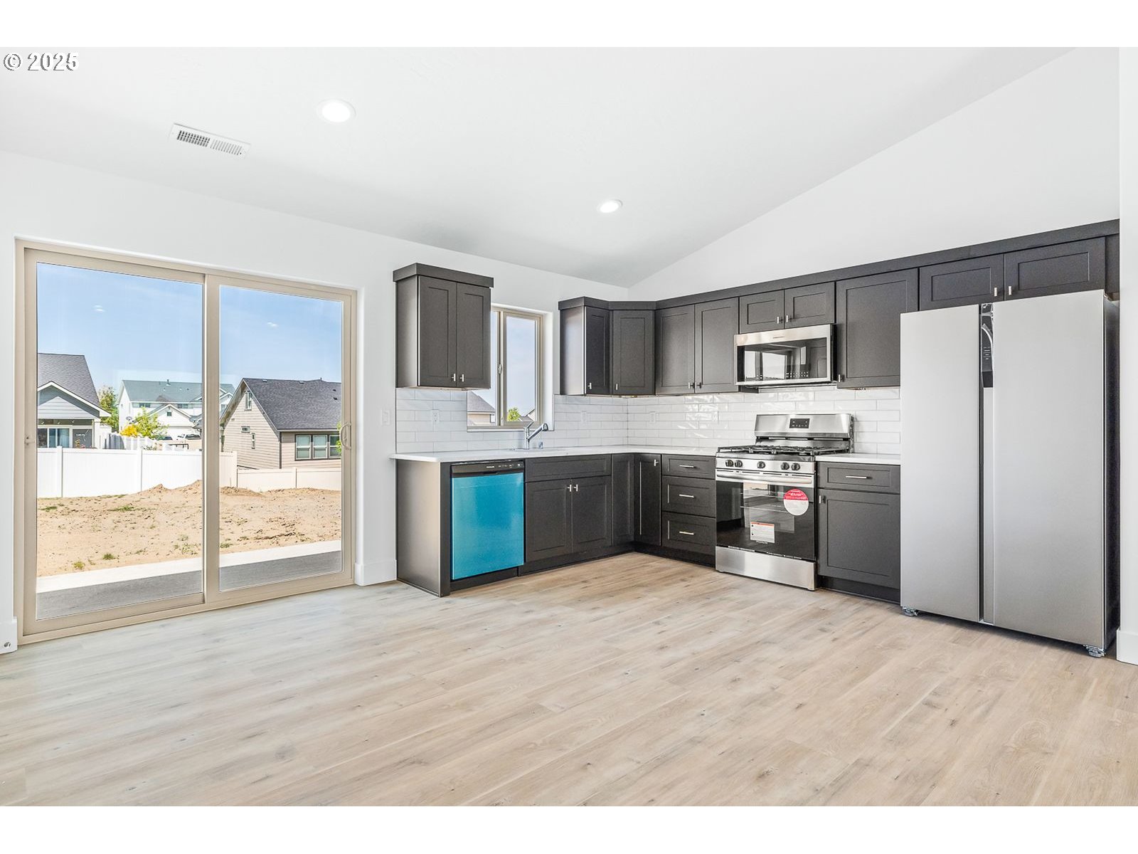 204 Tiber Street Boardman, OR 97818 - Photo 14 of 20 a kitchen with stainless steel appliances a refrigerator and a wooden floor