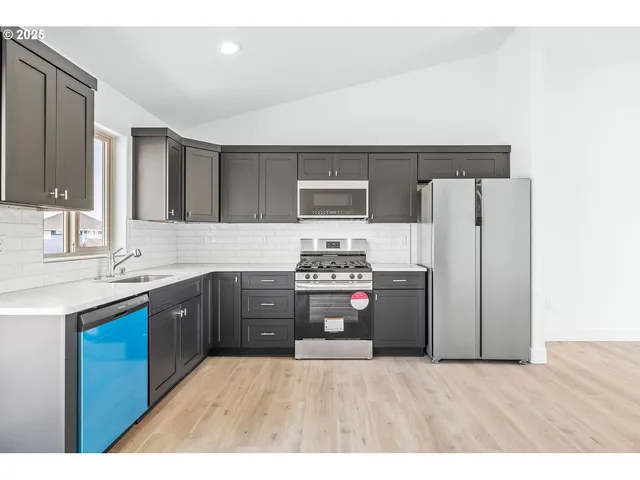 a kitchen with a refrigerator and a sink