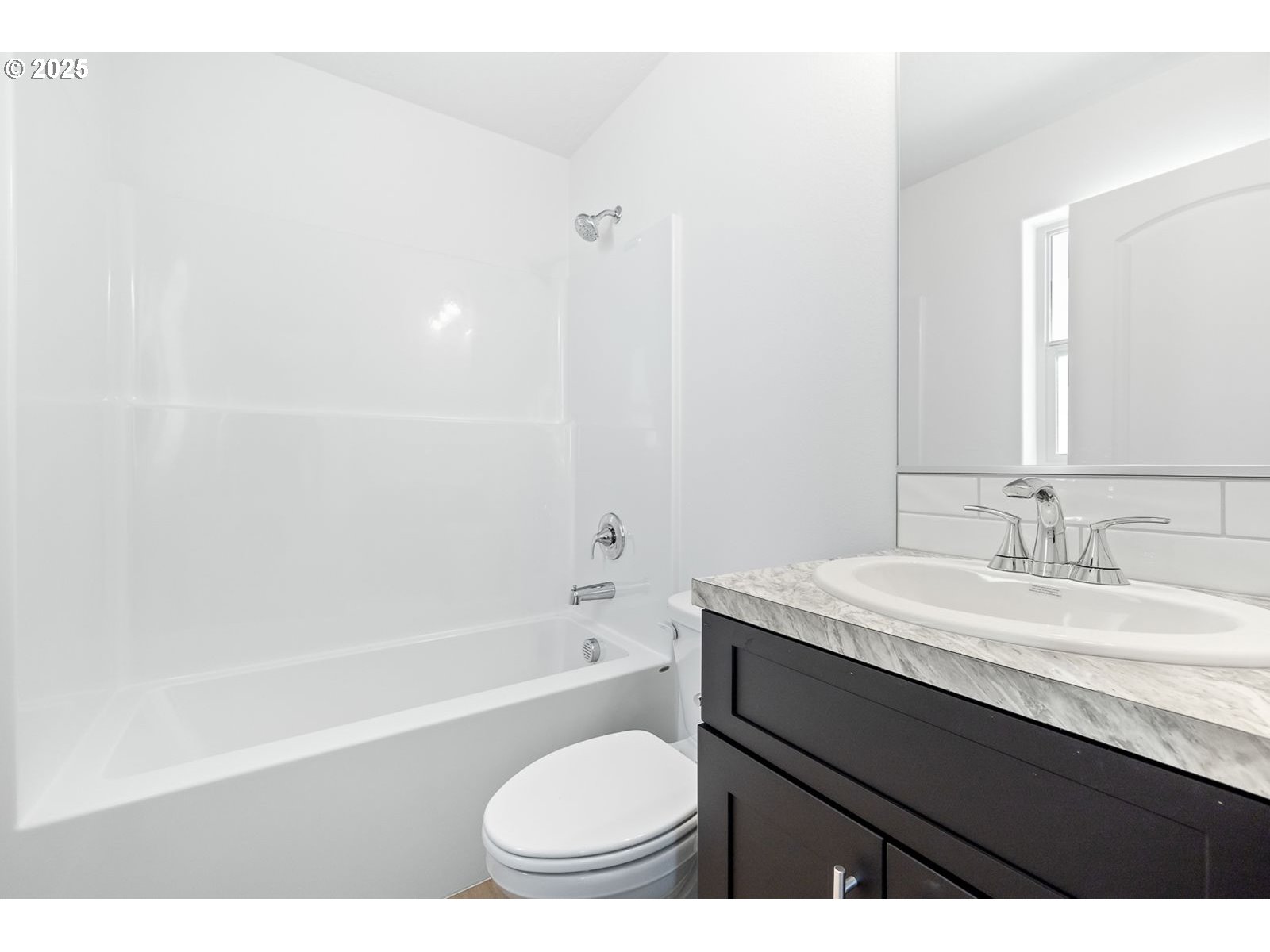 204 Tiber Street Boardman, OR 97818 - Photo 6 of 20 a bathroom with a granite countertop sink toilet a mirror and bathtub