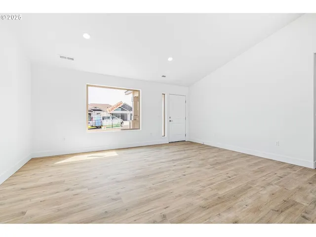 a view of an empty room and wooden floor