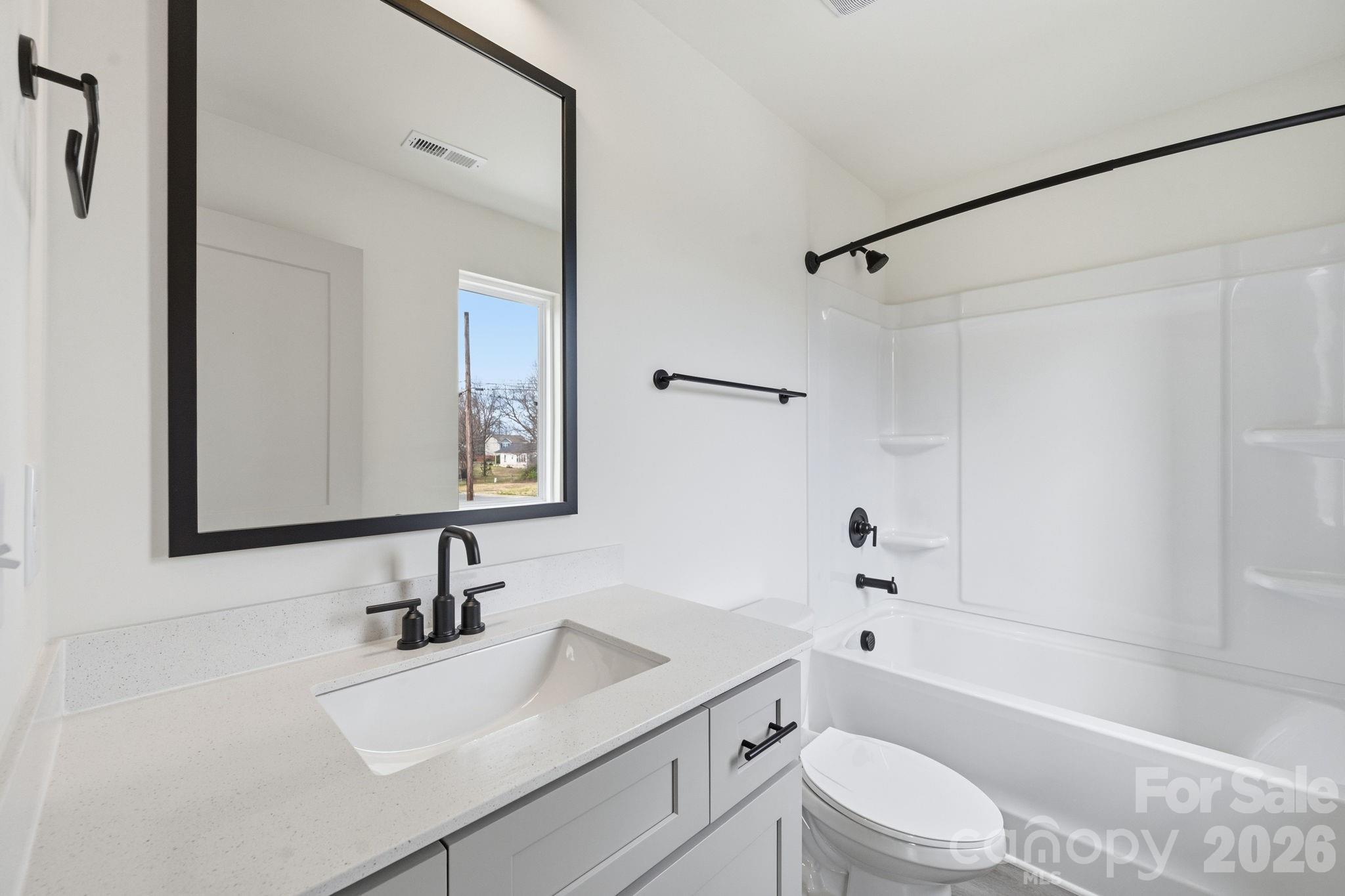 509 Beard Street Monroe, NC 28110 - Photo 19 of 33 a bathroom with a sink toilet a mirror and shower
