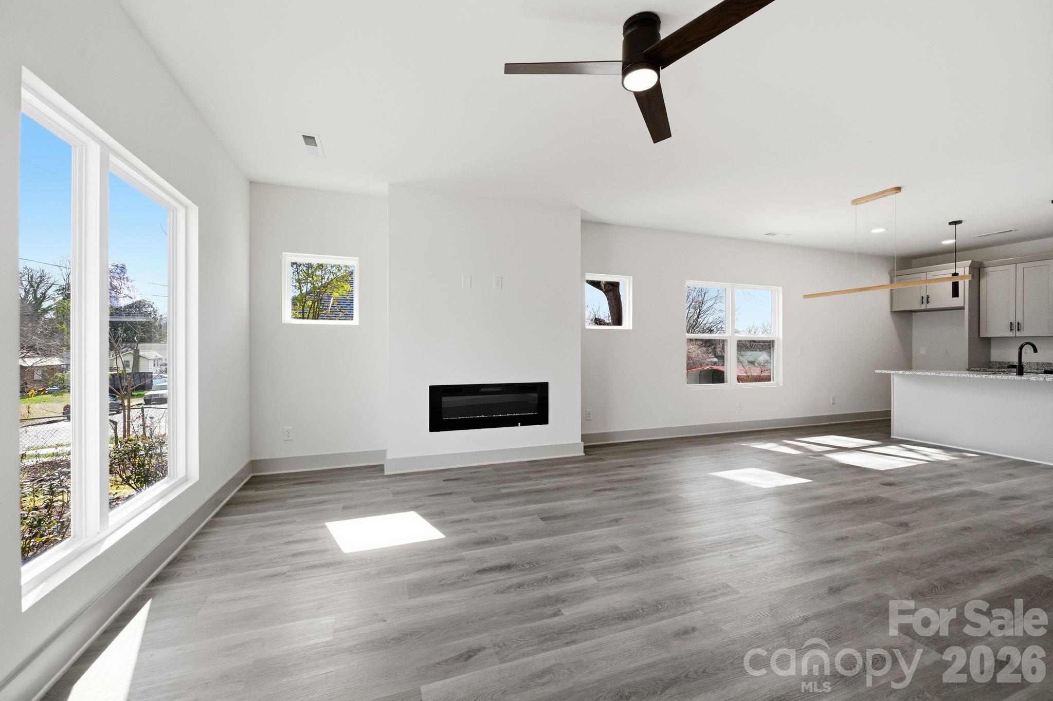 509 Beard Street Monroe, NC 28110 - Photo 6 of 33 a view of an empty room with window and wooden floor