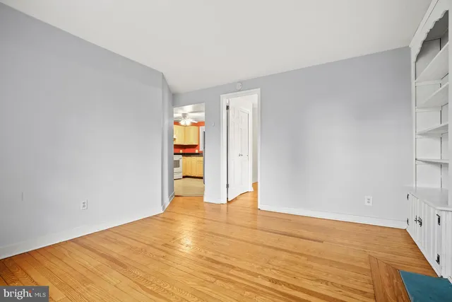 a view of empty room with wooden floor