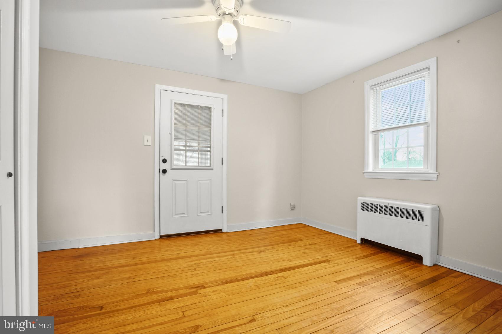 919 Valley Forge Road, Unit 1 Phoenixville, PA 19460 - Photo 14 of 25 a view of an empty room with wooden floor and a window