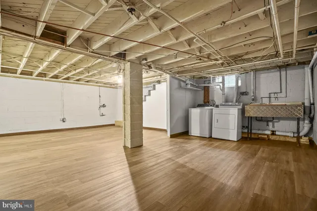 a view of a room with wooden floor