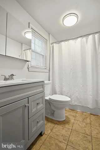 a bathroom with a toilet sink and vanity